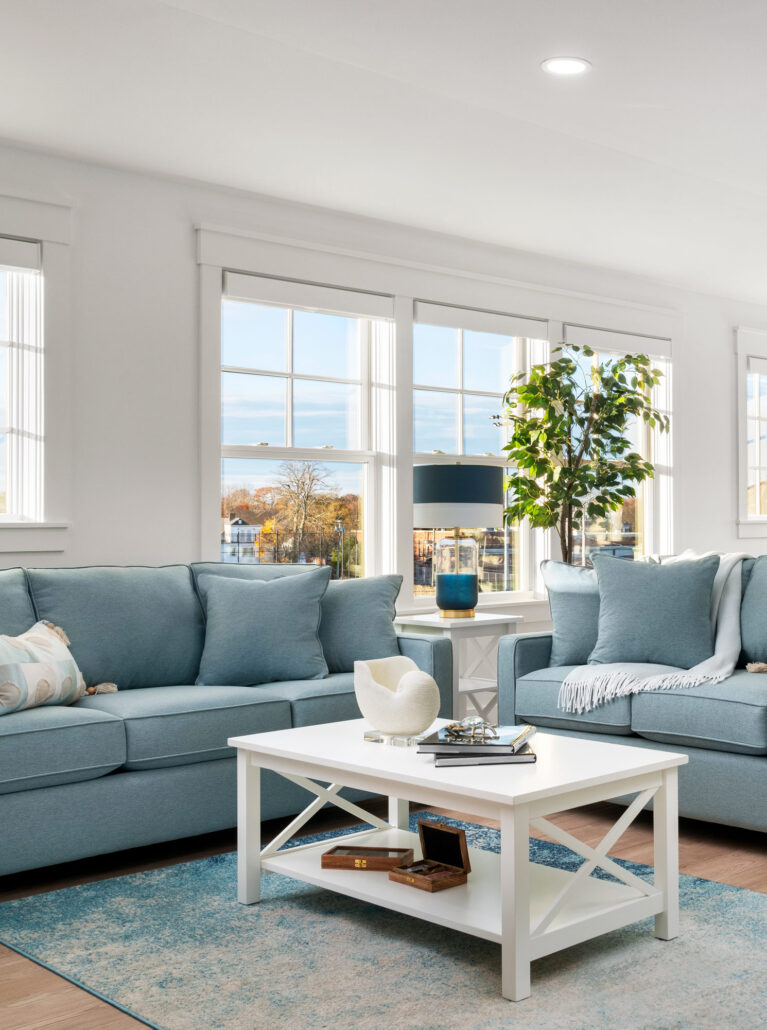 Cozy living room with plush sofas, a coffee table, and a side table with a lamp