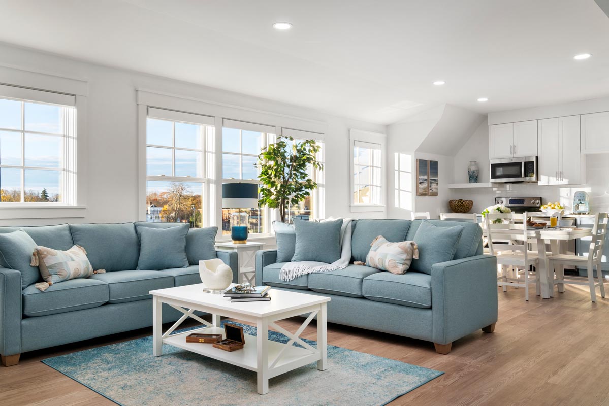 Cozy living room with plush sofas, a coffee table, and a side table with a lamp