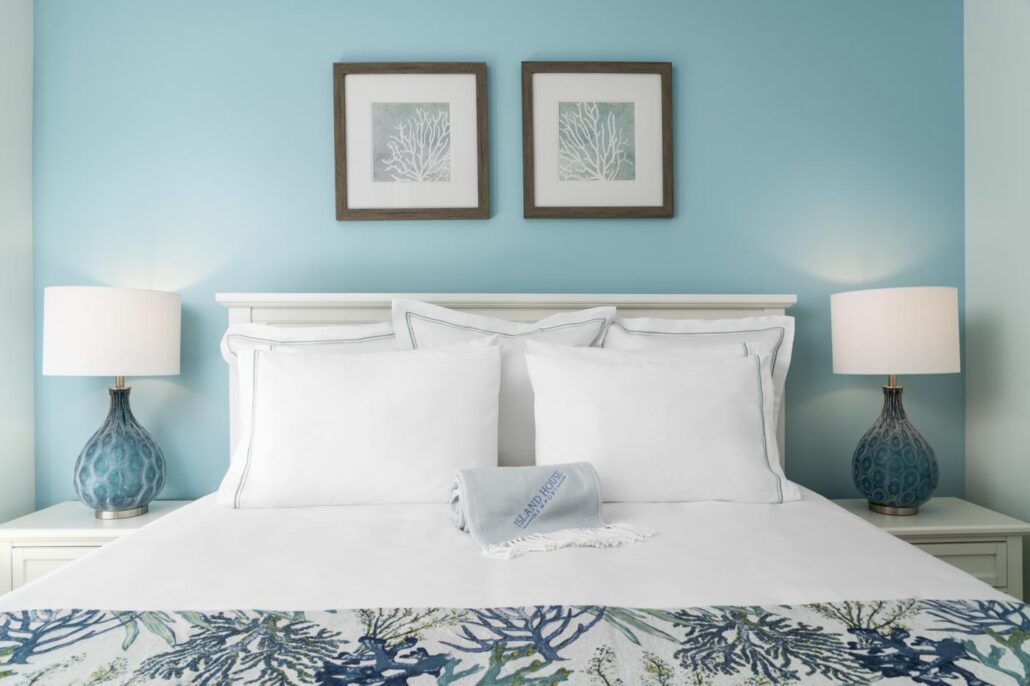 Bedroom with Island House Blanket and art above the bed.