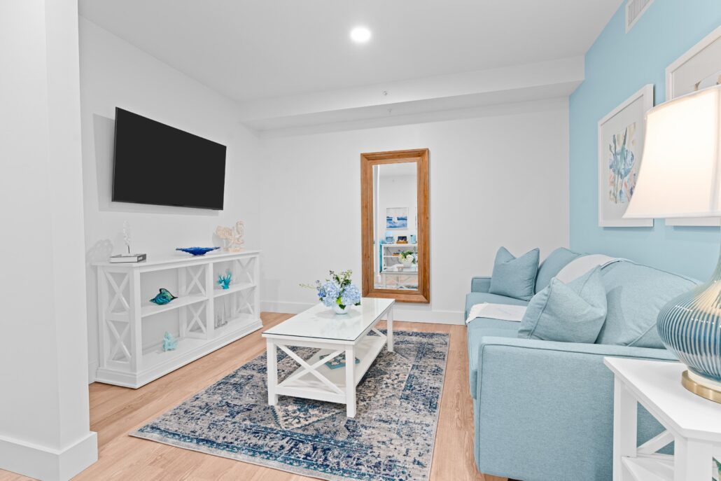 Living area with couch, coffee table, TV
